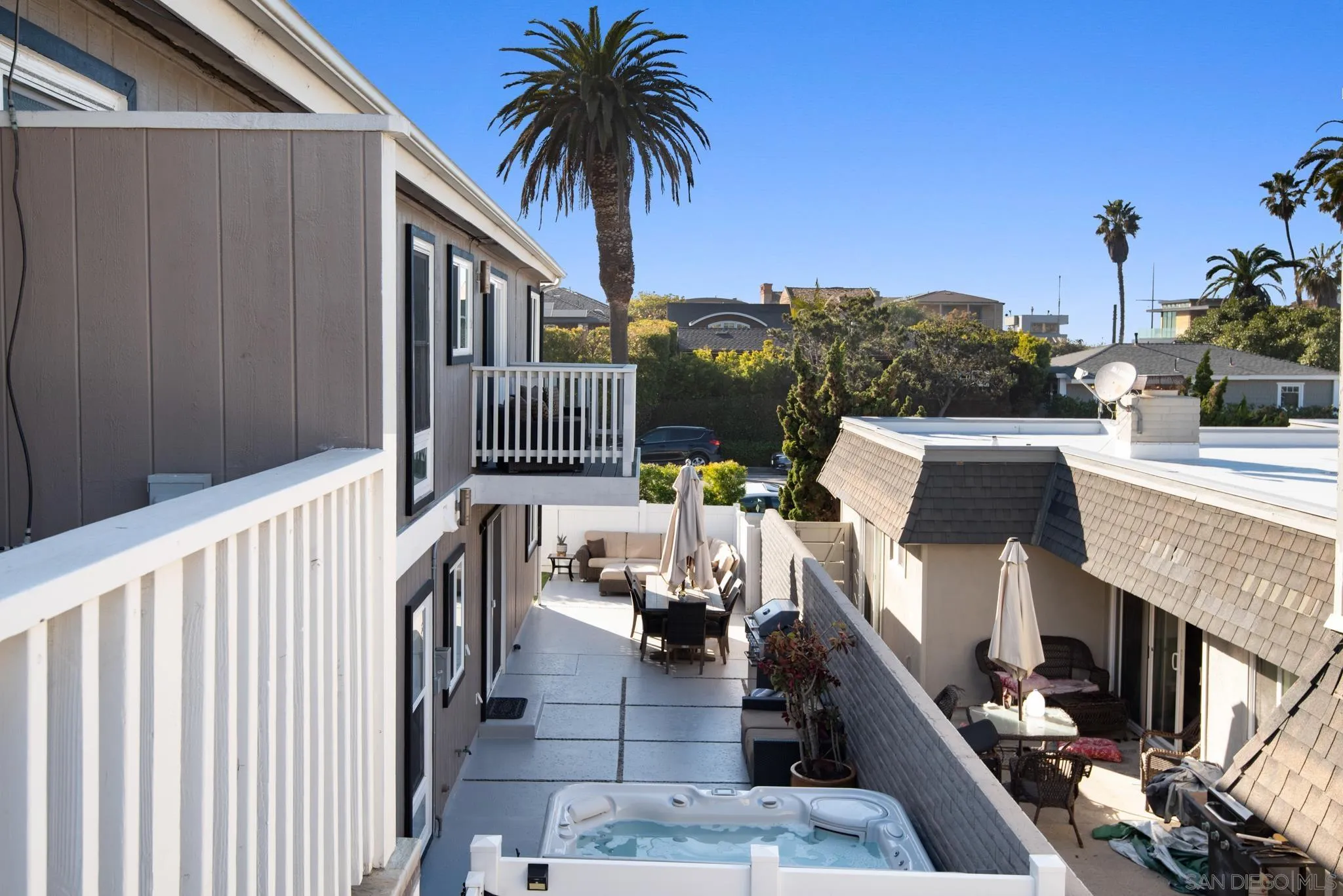 1933 Coast Boulevard Del Mar, CA 92014 - Photo 44 of 47 a balcony of a house with wooden floor outdoor seating and barbeque oven