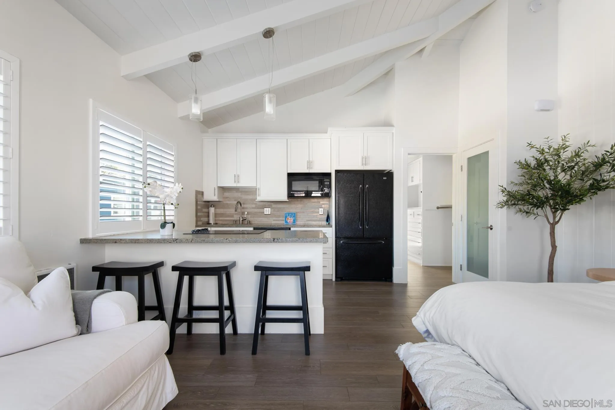 1933 Coast Boulevard Del Mar, CA 92014 - Photo 8 of 47 a kitchen with stainless steel appliances granite countertop a refrigerator a stove a sink dishwasher and white cabinets with wooden floor