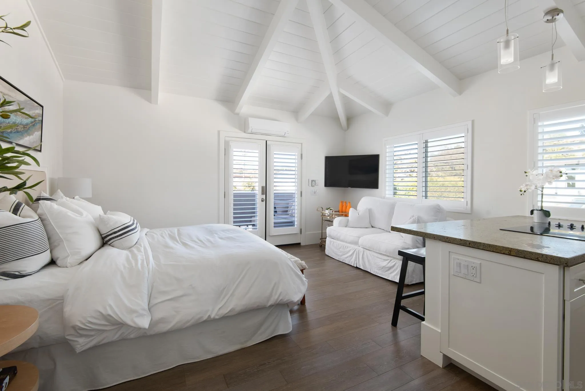 1933 Coast Boulevard Del Mar, CA 92014 - Photo 10 of 47 a bedroom with a bed and large windows
