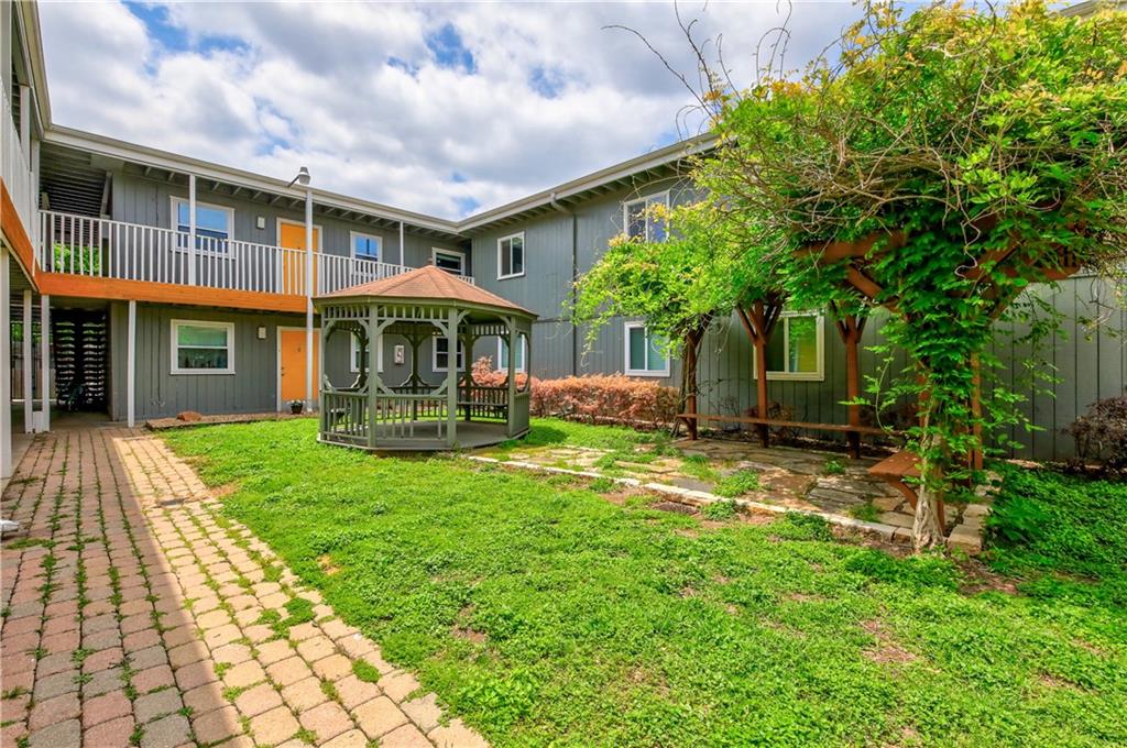 2401 Manor Road, Unit 221 Austin, TX 78722 - Photo 14 of 21 A private outdoor space with a charming gazebo and pergola, perfect for tranquil relaxation.