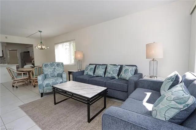 a living room with furniture and a lamp