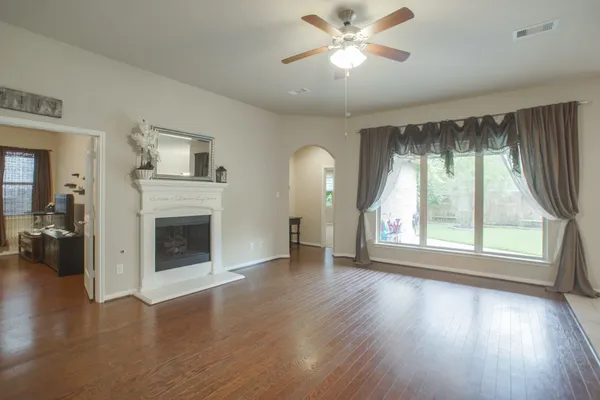 a view of a room with furniture and wooden floor