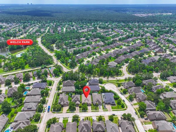 a view of a livingroom with a fireplace a chandelier and wooden floor