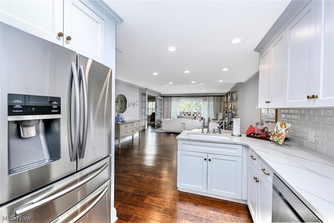 275 North Portage Path, Unit 3B Akron, OH 44303 - Photo 7 of 16 The kitchen features stainless steel appliances, white cabinetry, a white countertop, and a white subway tile backsplash