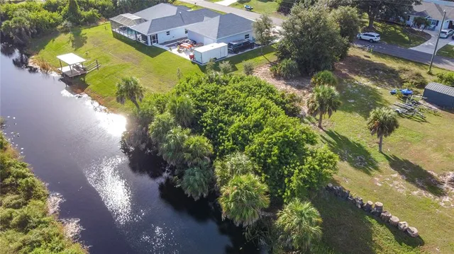 an aerial view of residential houses with outdoor space and swimming pool