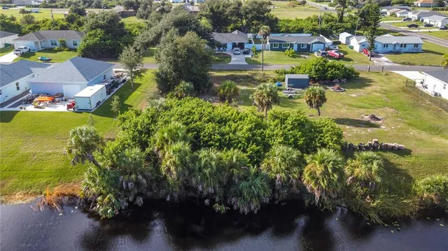 an aerial view of residential houses with outdoor space and swimming pool