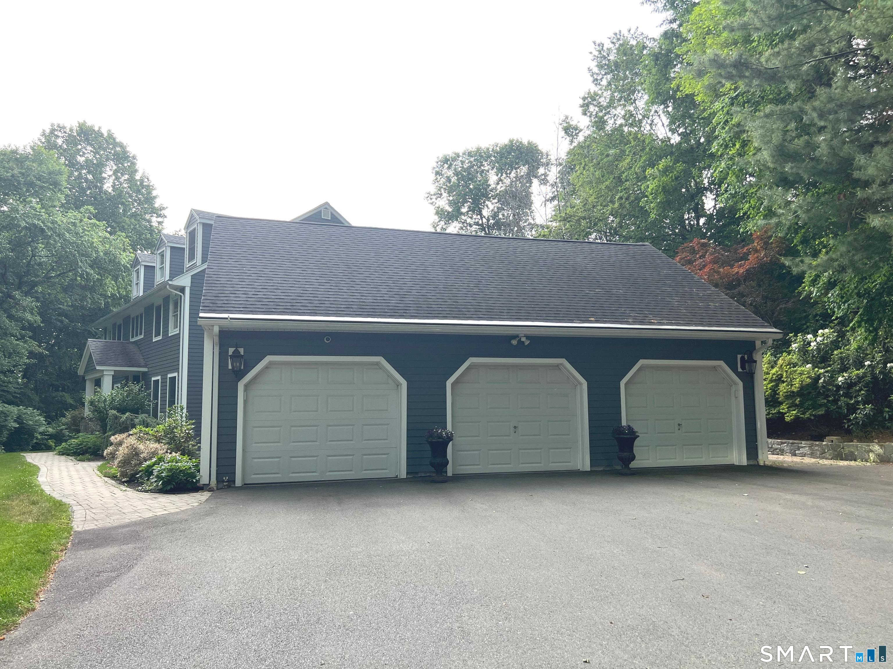 60 West Meadow Road Hamden, CT 06518 - Photo 3 of 37 Spacious three-car garage with plenty of room for vehicles and storage.