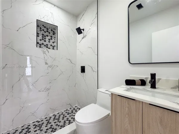 a bathroom with a toilet sink and shower