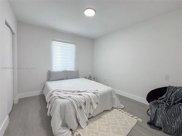 a bedroom with a bed and chair