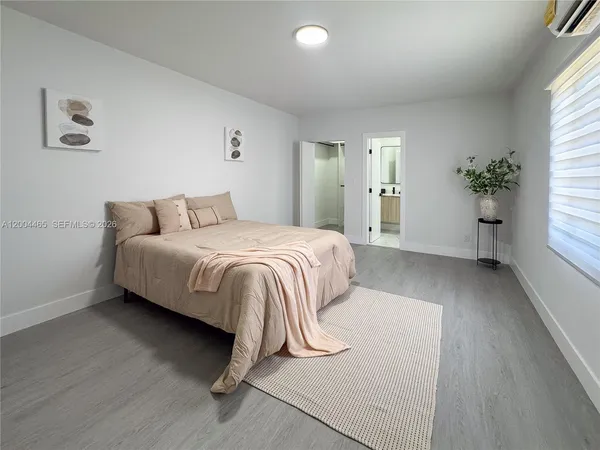 a bedroom with a bed and a potted plant