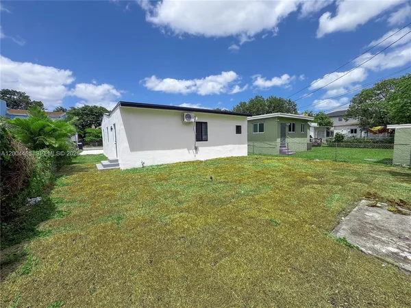 a front view of house with yard and trees