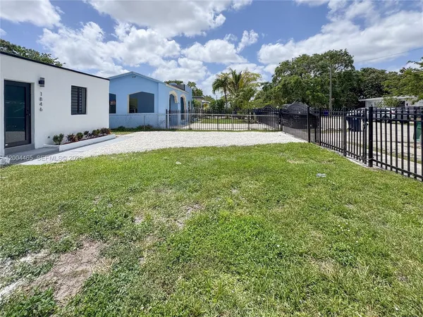 a front view of house with yard and trees