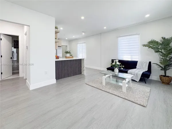 a living room with furniture and a potted plant