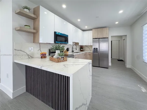a kitchen with refrigerator and cabinets