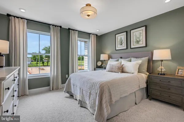 a bedroom with a bed and a night stand