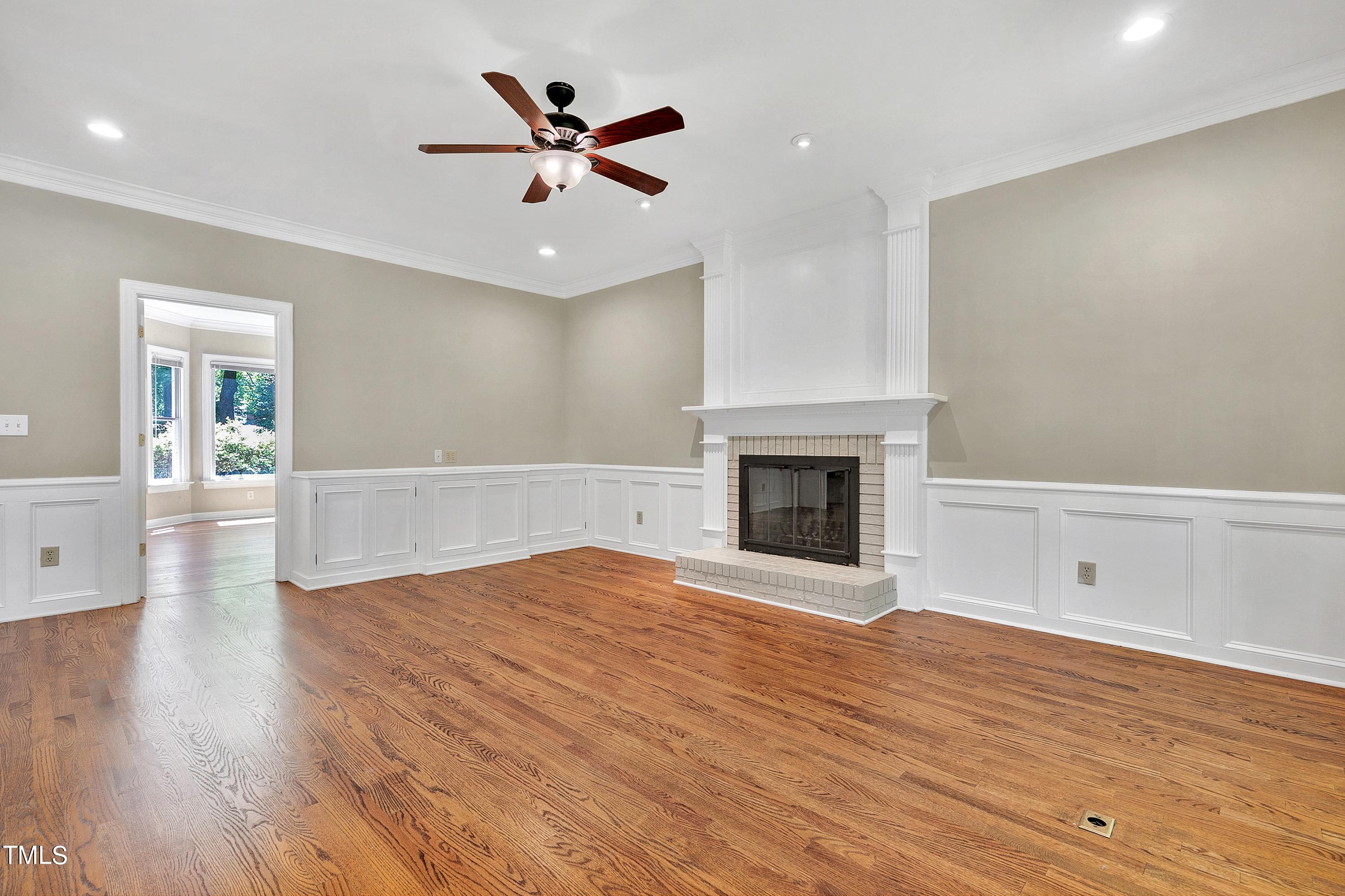 100 Buckden Place Cary, NC 27518 - Photo 11 of 70 a view of an empty room with wooden floor fireplace and a window