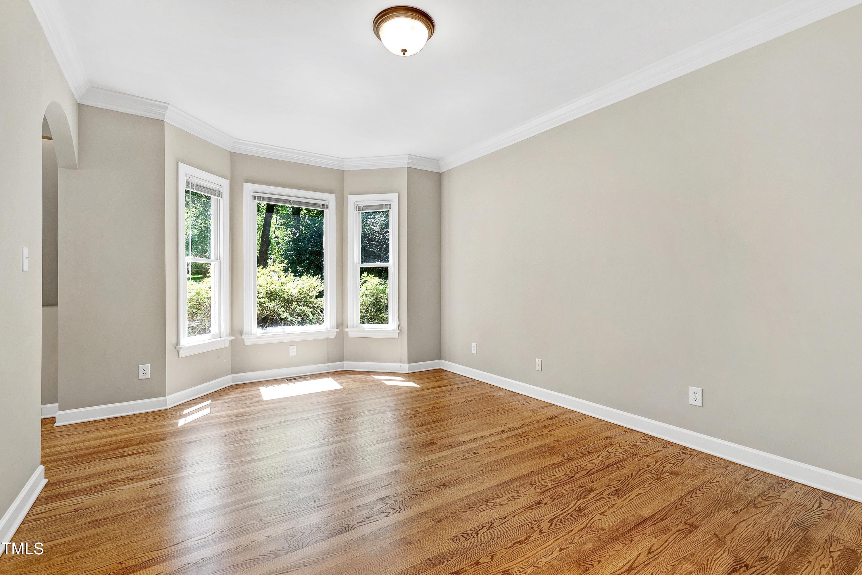 100 Buckden Place Cary, NC 27518 - Photo 22 of 70 a view of an empty room with wooden floor and a window