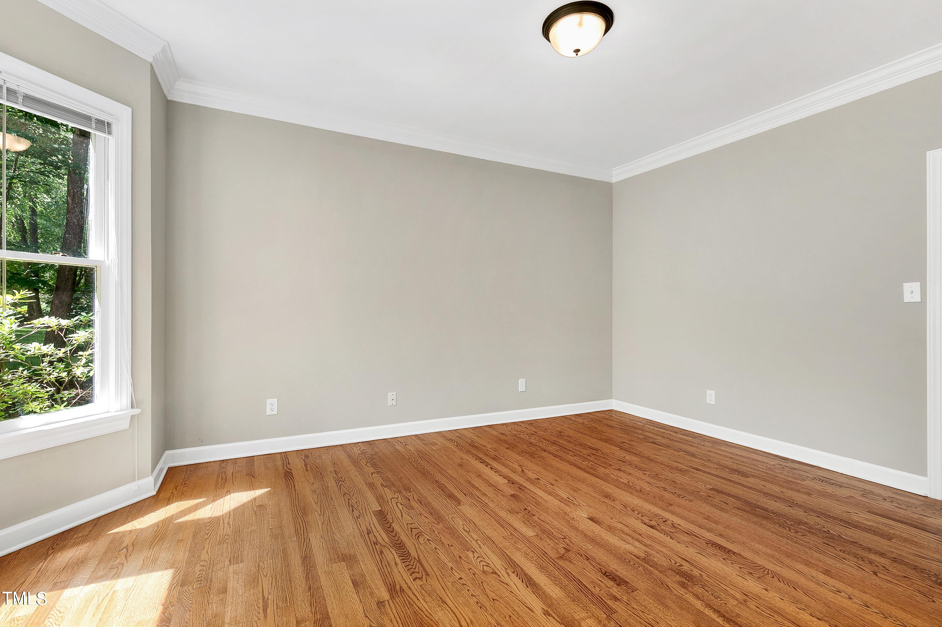 100 Buckden Place Cary, NC 27518 - Photo 23 of 70 wooden floor in an empty room with a window