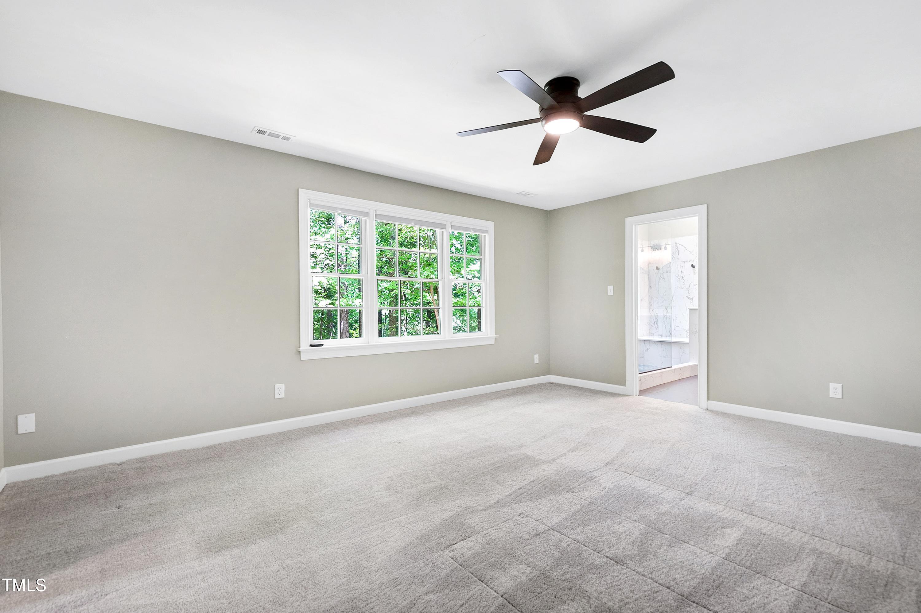 100 Buckden Place Cary, NC 27518 - Photo 26 of 70 an empty room with ceiling fan and windows
