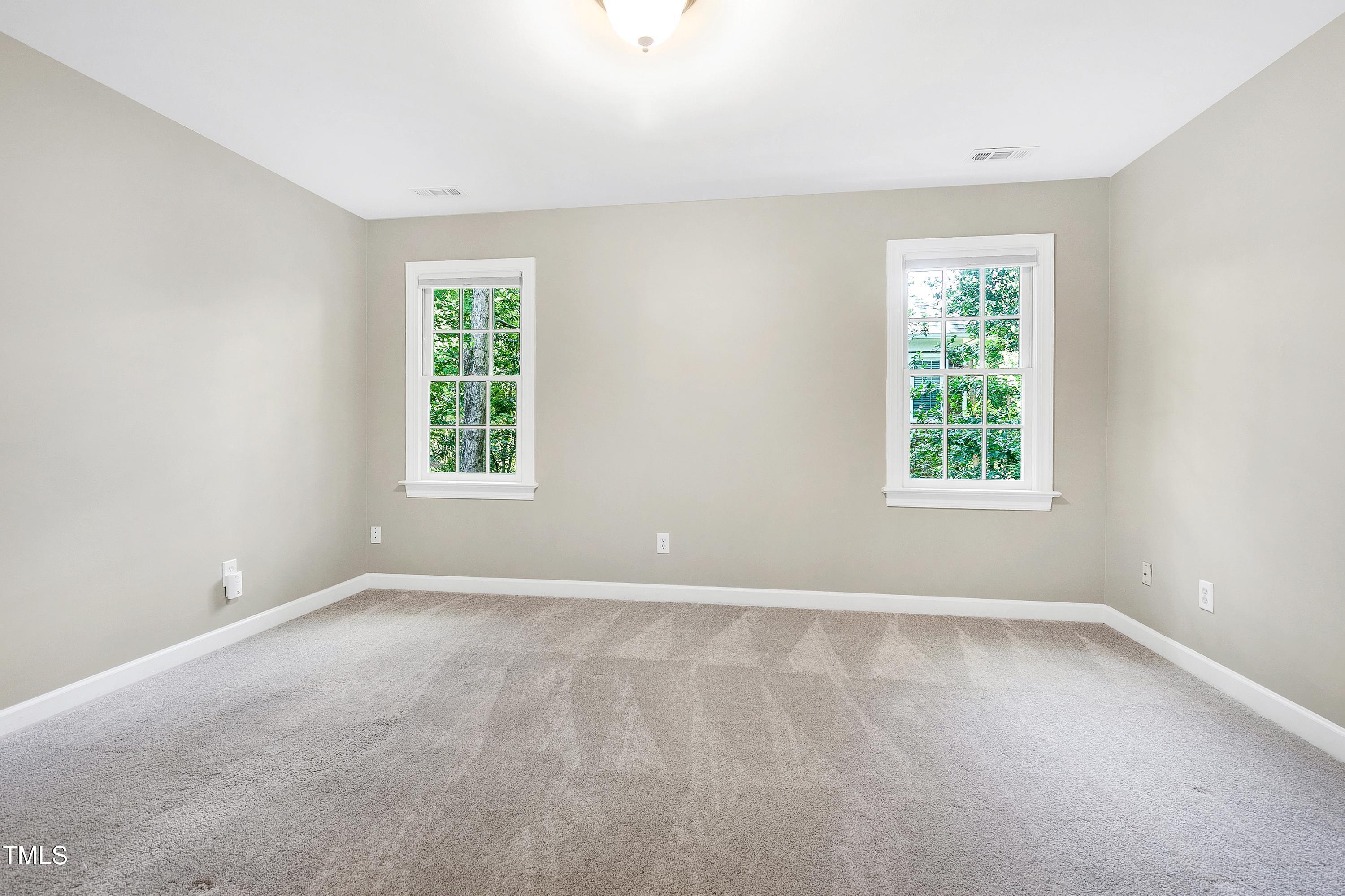 100 Buckden Place Cary, NC 27518 - Photo 27 of 70 an empty room with windows