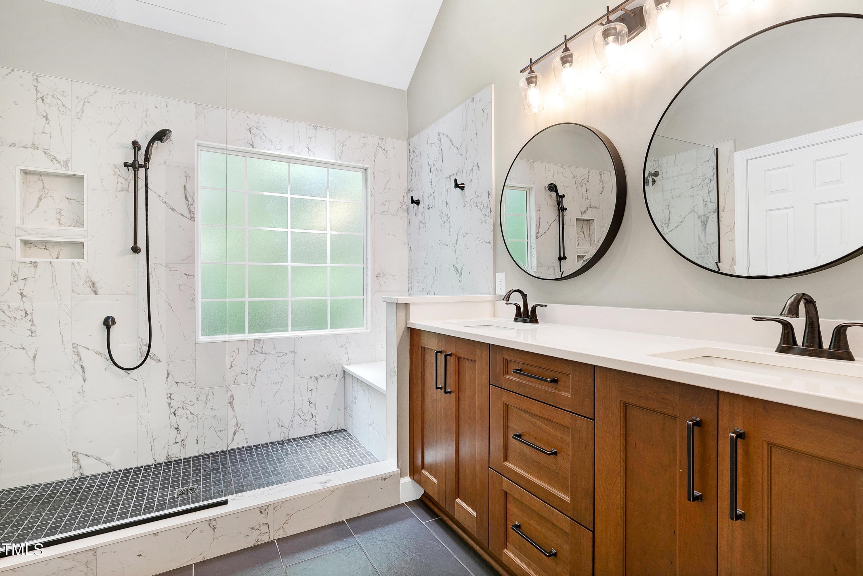 100 Buckden Place Cary, NC 27518 - Photo 29 of 70 a bathroom with a double vanity sink mirror and bathtub