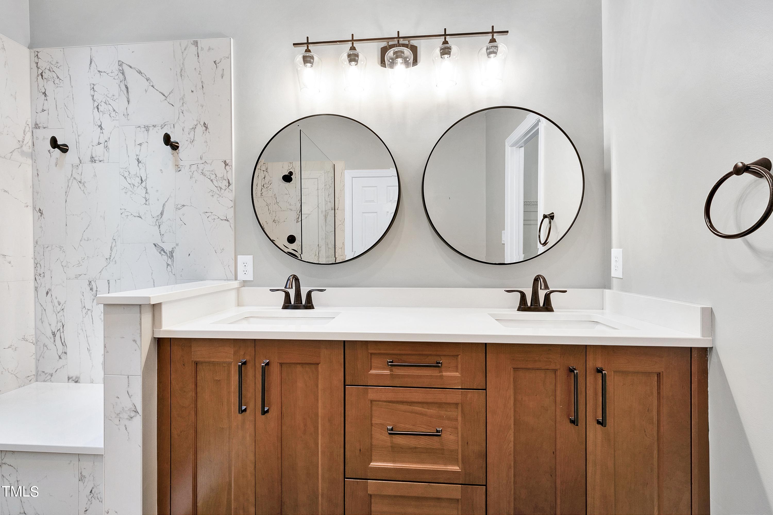 100 Buckden Place Cary, NC 27518 - Photo 32 of 70 a bathroom with a sink and a mirror