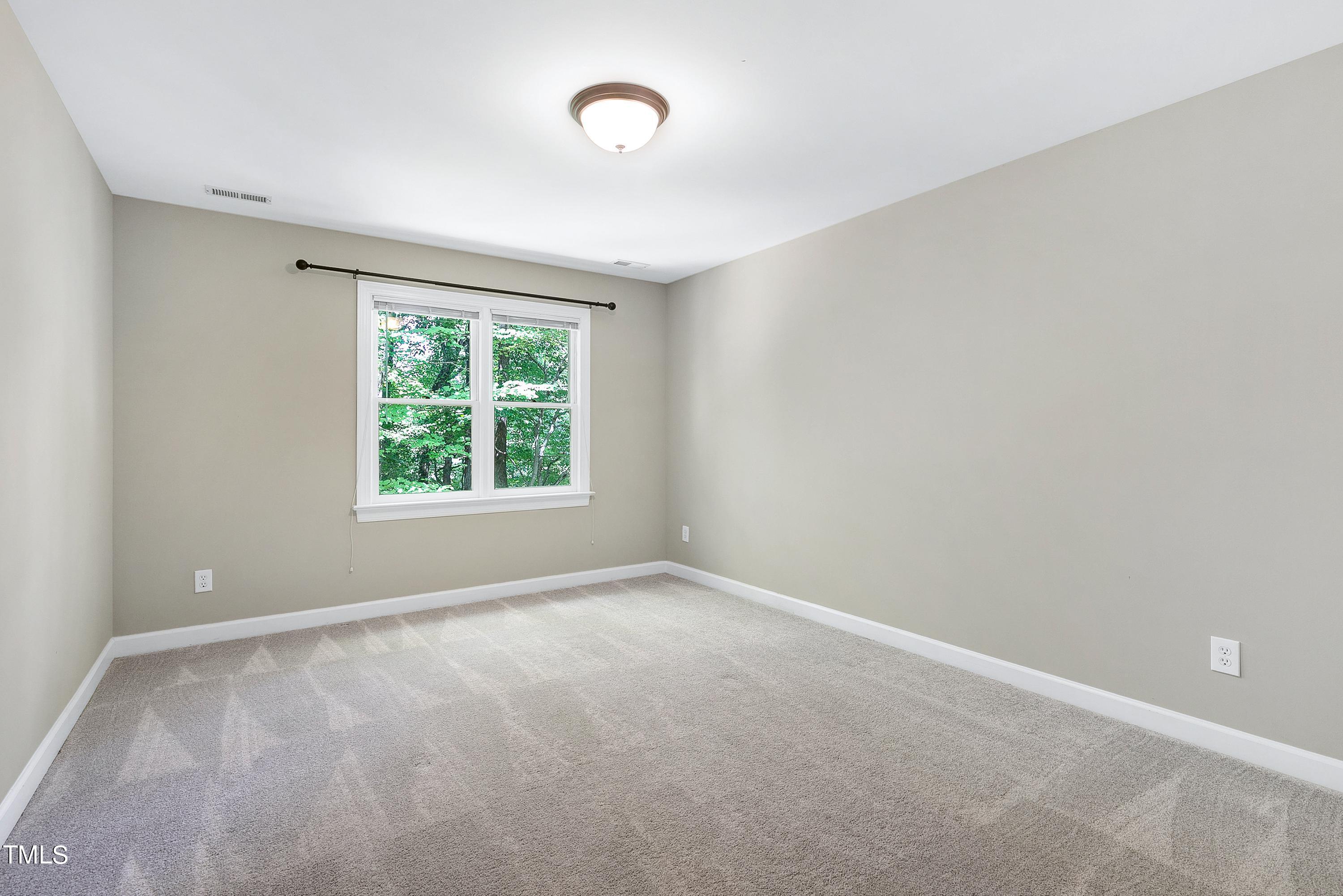 100 Buckden Place Cary, NC 27518 - Photo 36 of 70 an empty room with windows