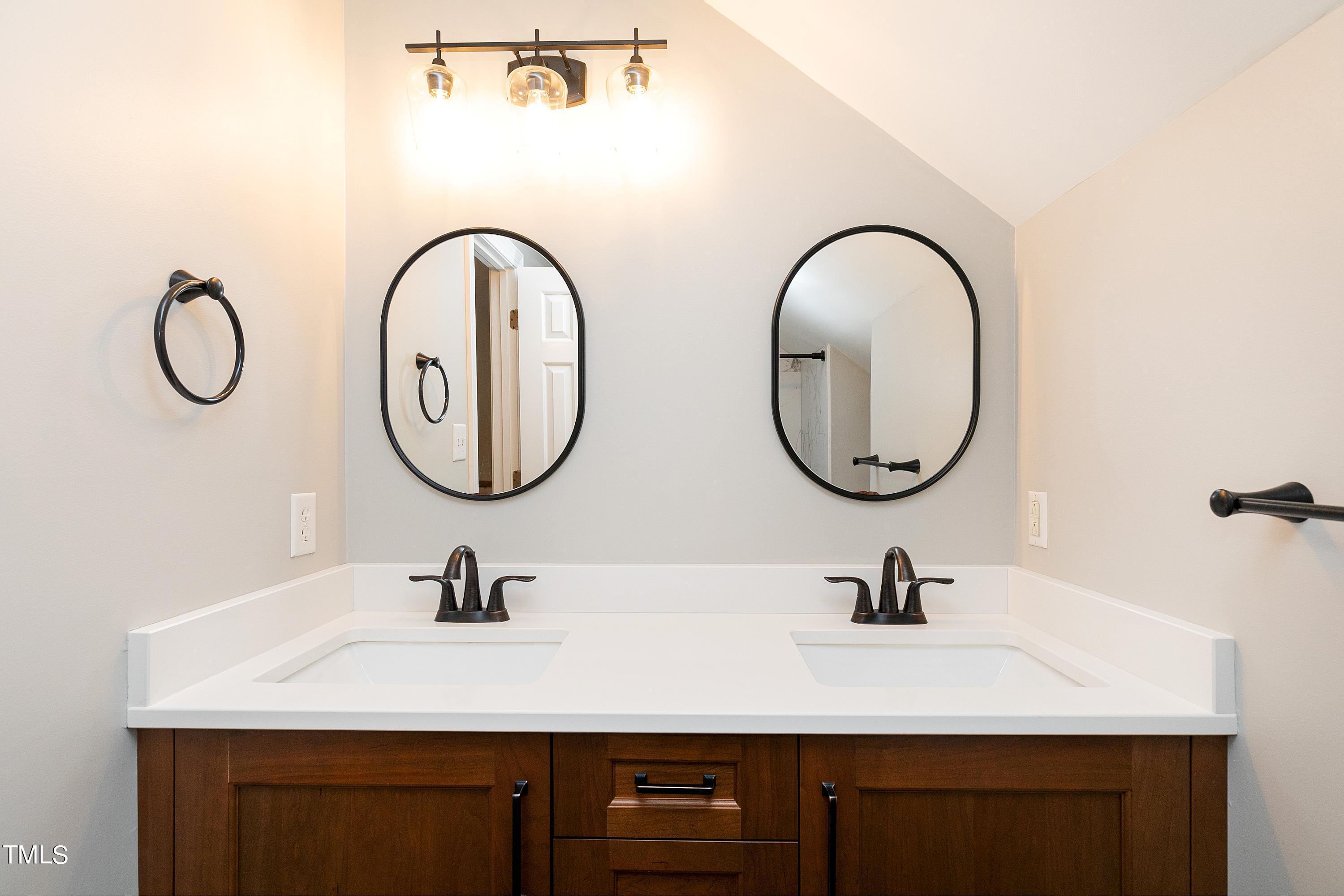 100 Buckden Place Cary, NC 27518 - Photo 38 of 70 a bathroom with a double vanity sinks and a mirror
