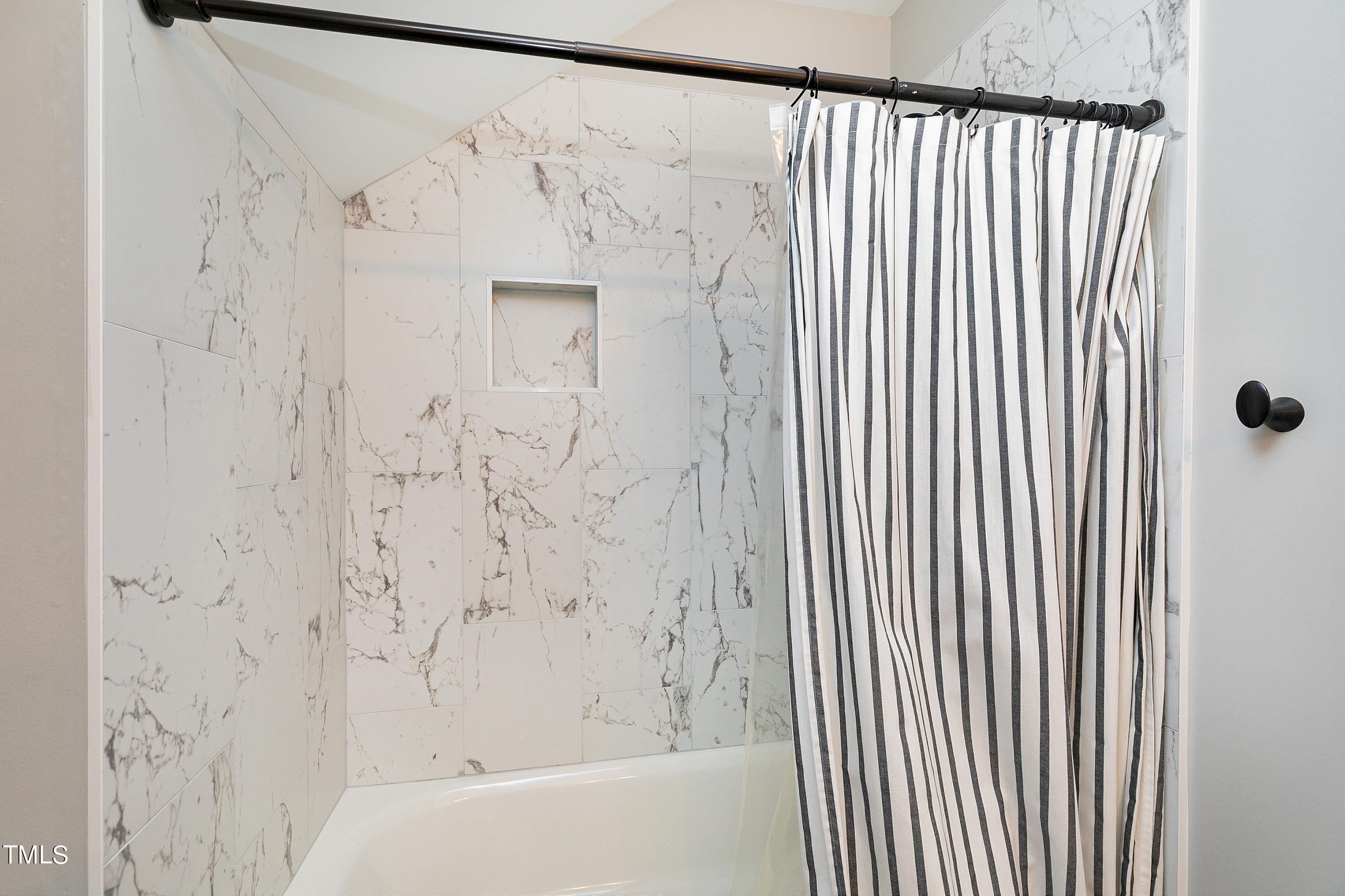 100 Buckden Place Cary, NC 27518 - Photo 40 of 70 a bathroom with a bathtub and shower