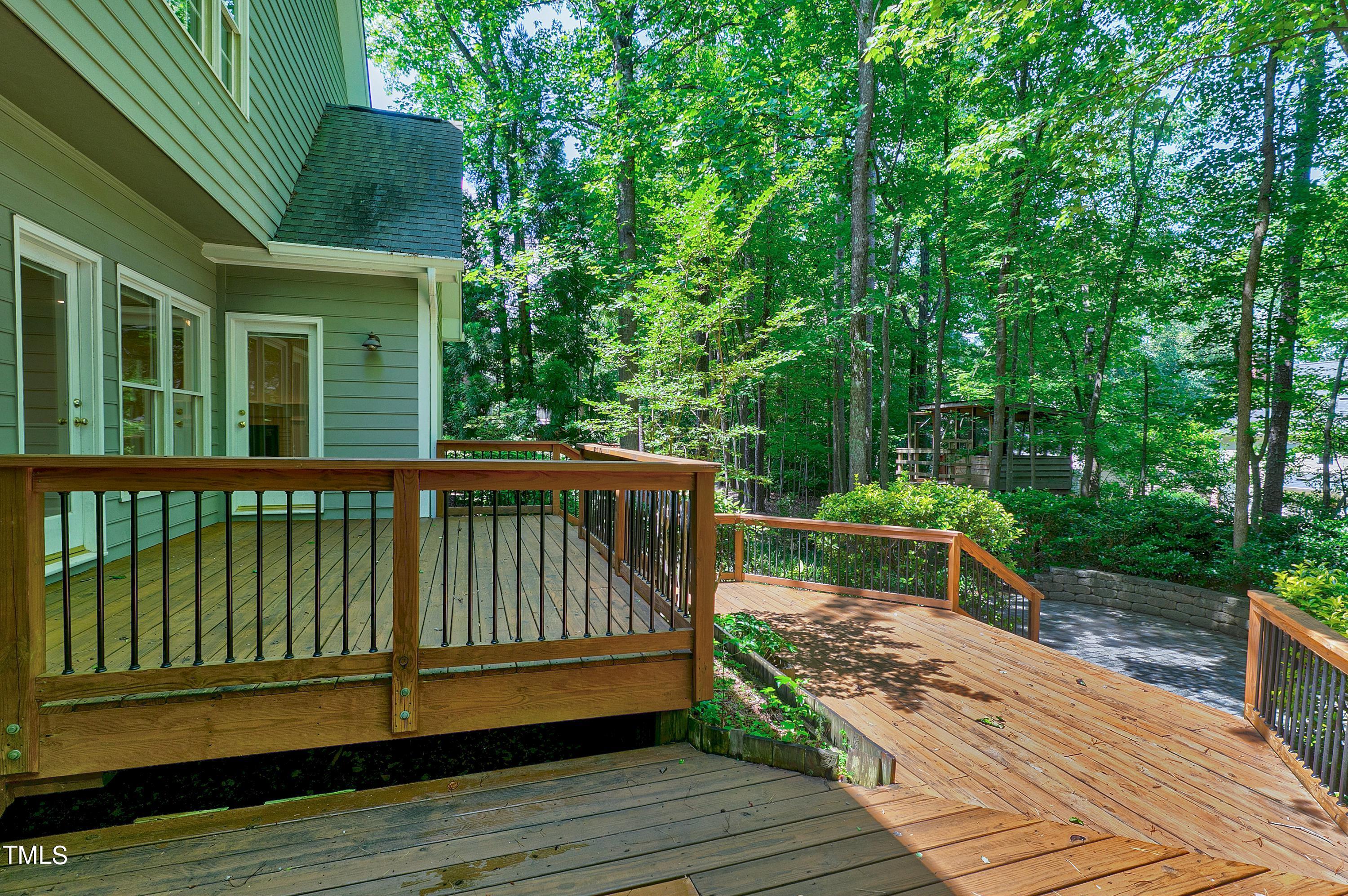 100 Buckden Place Cary, NC 27518 - Photo 47 of 70 a view of a wooden deck with a bench