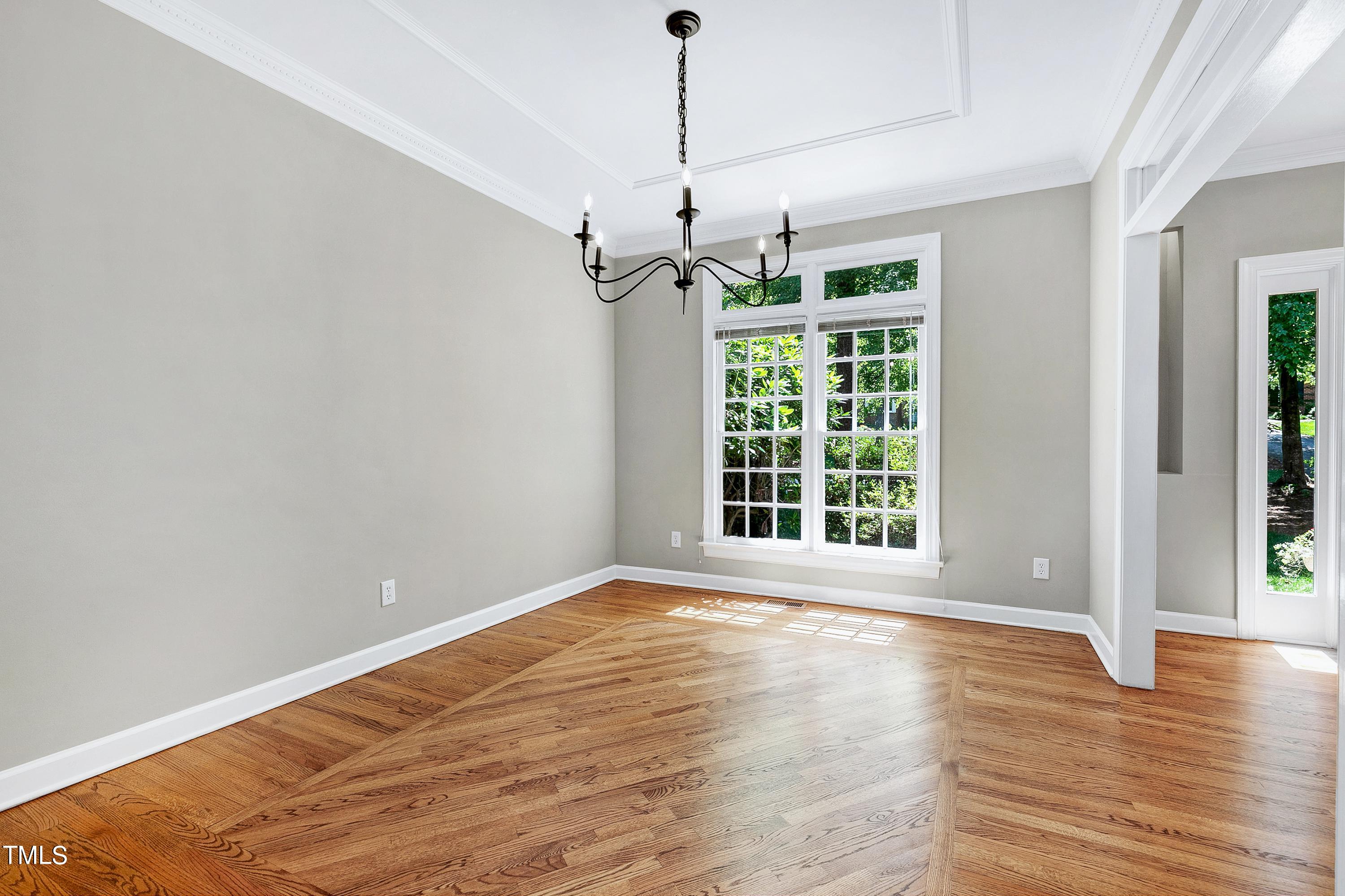 100 Buckden Place Cary, NC 27518 - Photo 7 of 70 a view of a room with wooden floor chandelier and windows