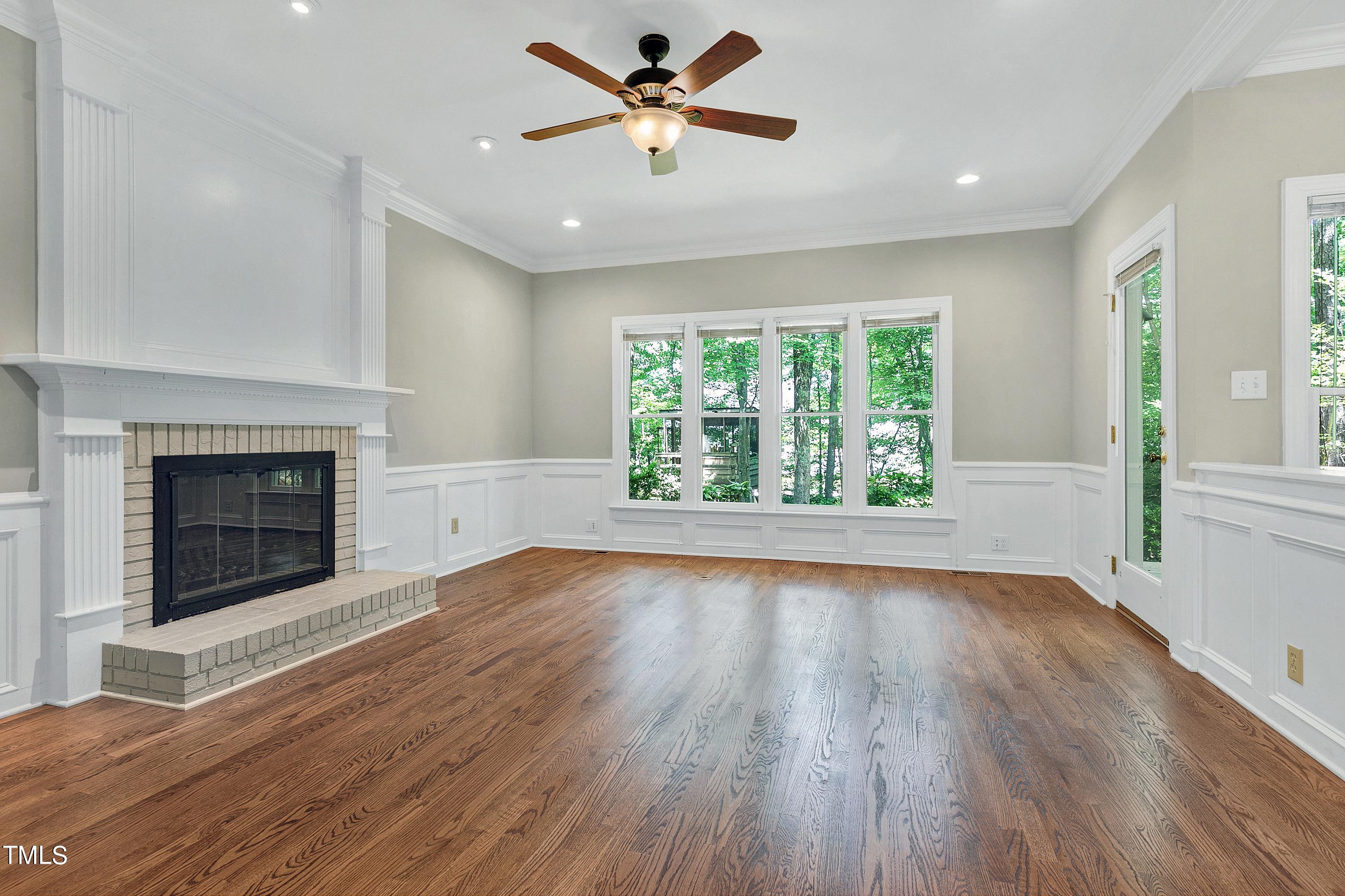 100 Buckden Place Cary, NC 27518 - Photo 9 of 70 an empty room with windows fireplace and a sink