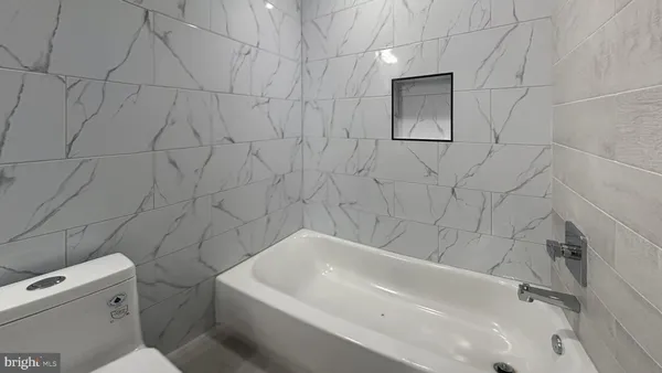 a bathroom with a bathtub and toilet