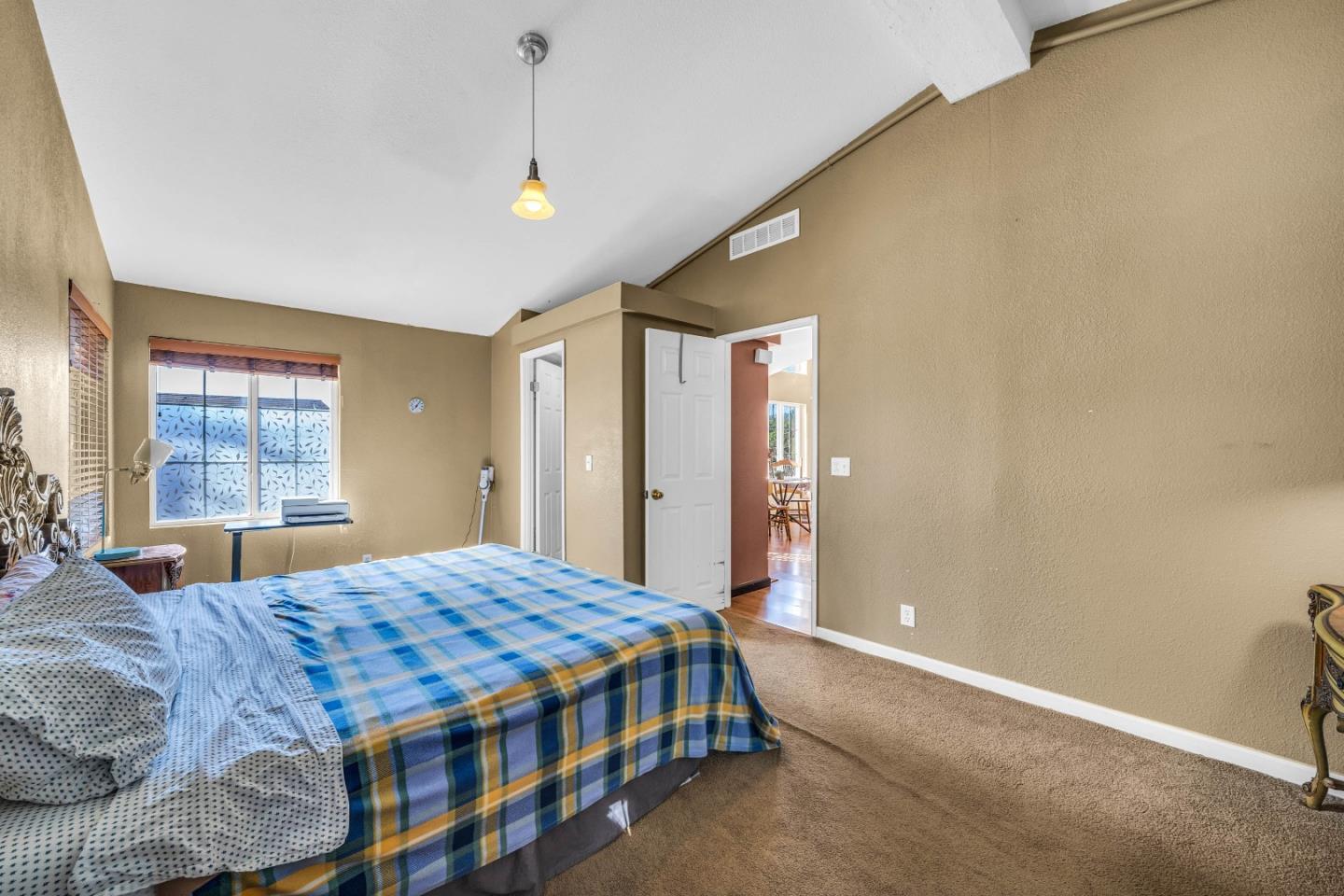 8645 Archer Road Salinas, CA 93907 - Photo 25 of 60 a bedroom with a large bed chandelier and a window