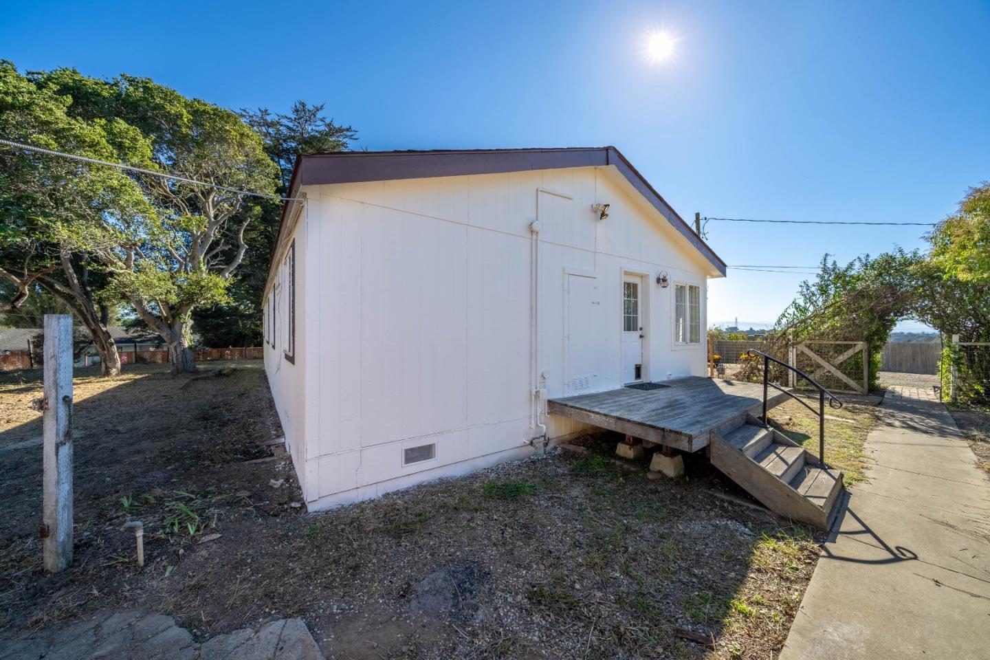 8645 Archer Road Salinas, CA 93907 - Photo 36 of 60 a backyard of a house with wooden fence and large trees