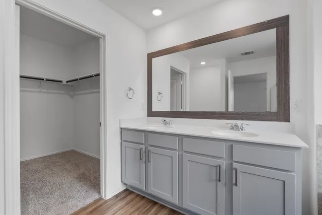 a bathroom with a double vanity sink and a mirror