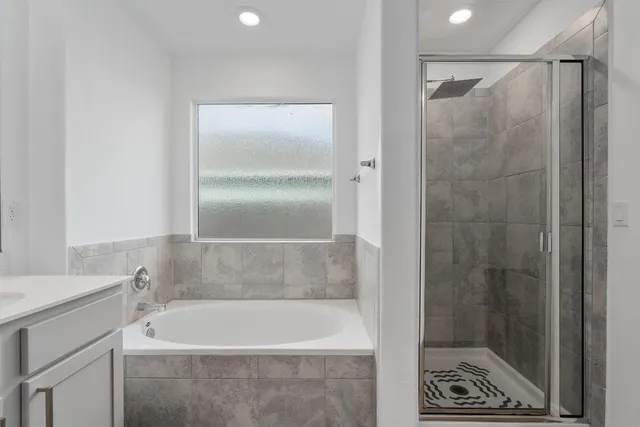 a bathroom with a bathtub and a shower