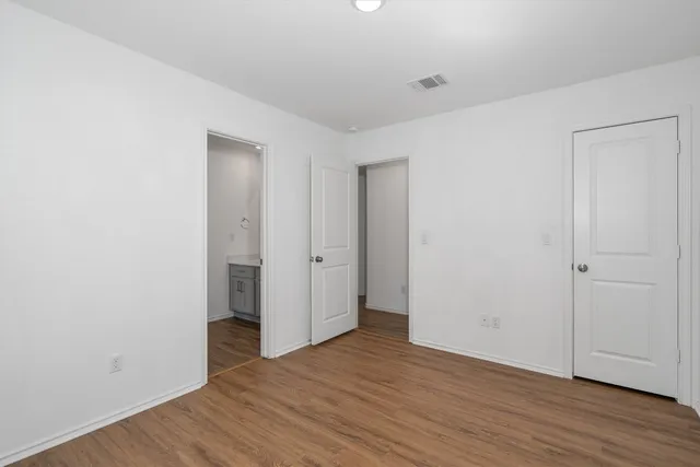 a view of a room with wooden floor