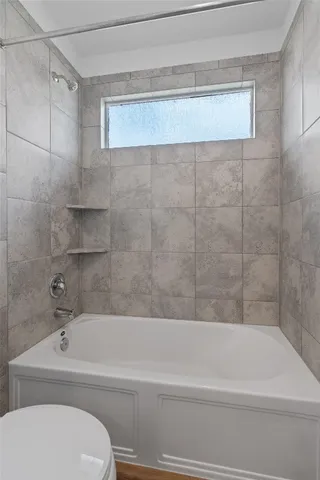 a bathroom with a bathtub and a toilet