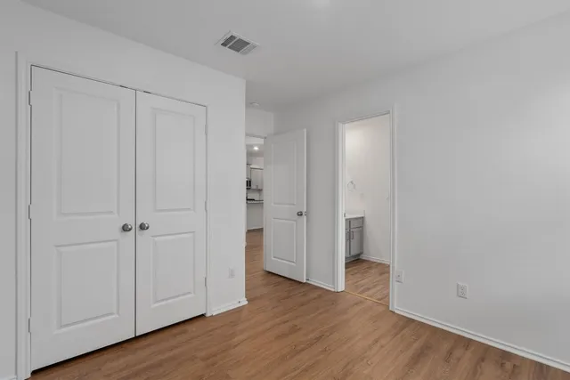a view of an empty room and wooden floor