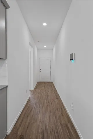 a view of a room with wooden floor