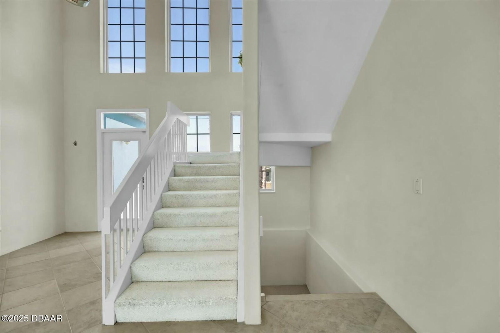 4363 South Atlantic Avenue Ponce Inlet, FL 32127 - Photo 14 of 46 a view of staircase with white walls and windows