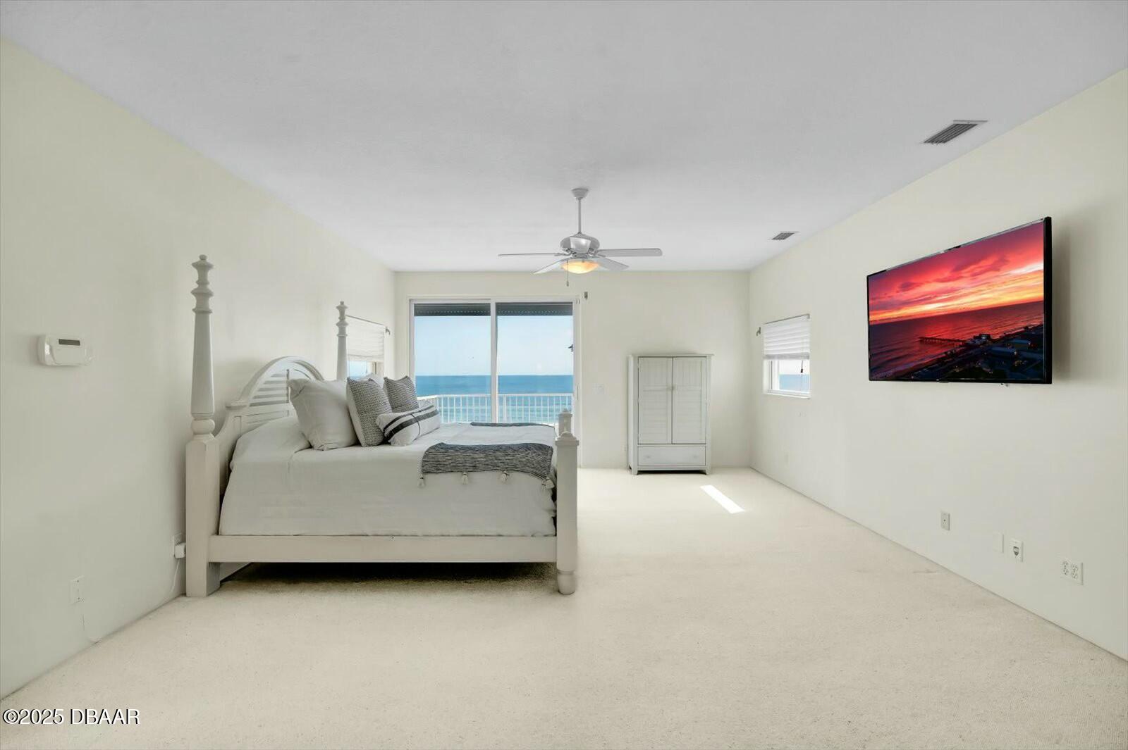 4363 South Atlantic Avenue Ponce Inlet, FL 32127 - Photo 16 of 46 a living room with furniture and a flat screen tv