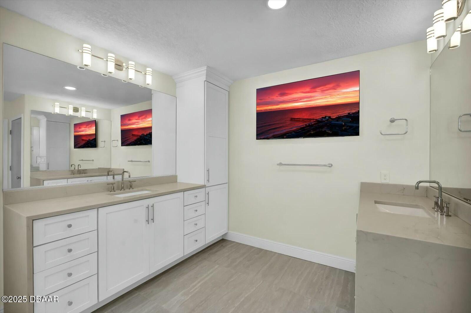 4363 South Atlantic Avenue Ponce Inlet, FL 32127 - Photo 19 of 46 a spacious bathroom with a double vanity sink and a mirror