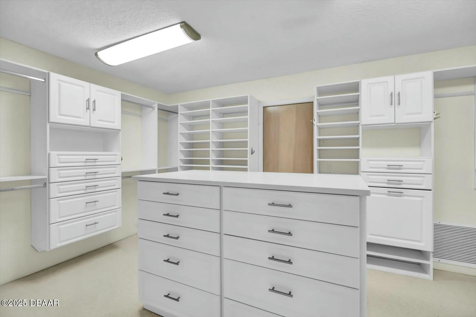 4363 South Atlantic Avenue Ponce Inlet, FL 32127 - Photo 20 of 46 a kitchen with white cabinets and window