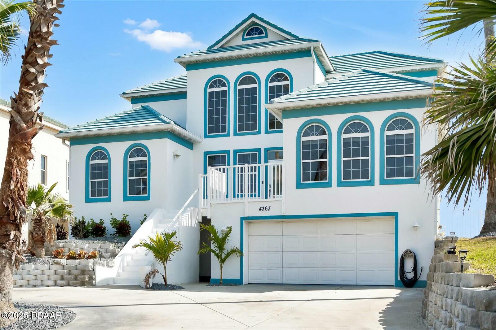 4363 South Atlantic Avenue Ponce Inlet, FL 32127 - Photo 2 of 46 a front view of a house with a garden