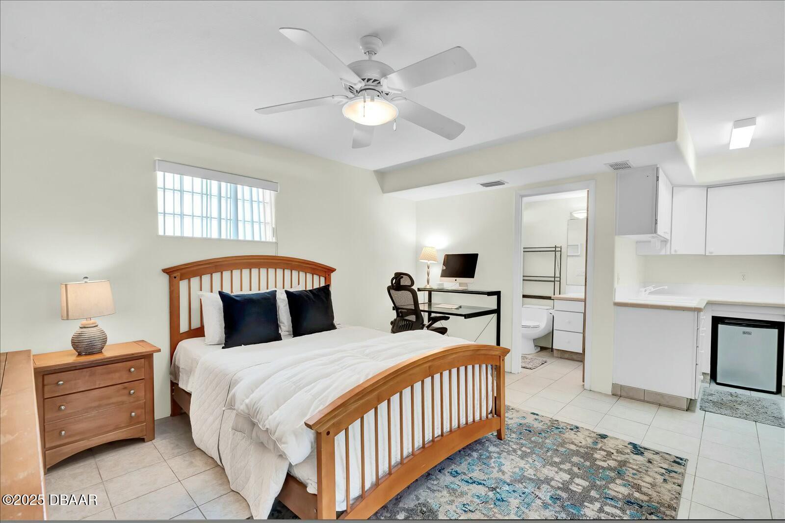 4363 South Atlantic Avenue Ponce Inlet, FL 32127 - Photo 23 of 46 a bed room with a bed and a chandelier