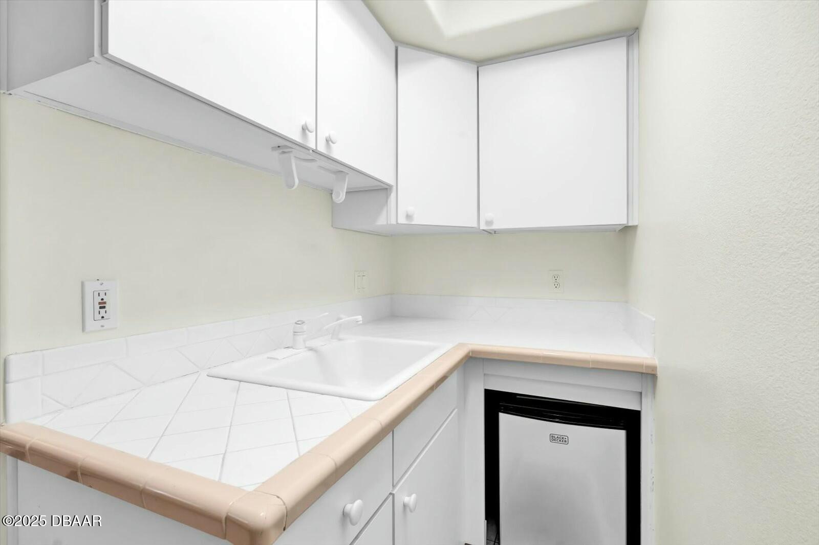 4363 South Atlantic Avenue Ponce Inlet, FL 32127 - Photo 24 of 46 a view of a kitchen cabinets a sink and dishwasher