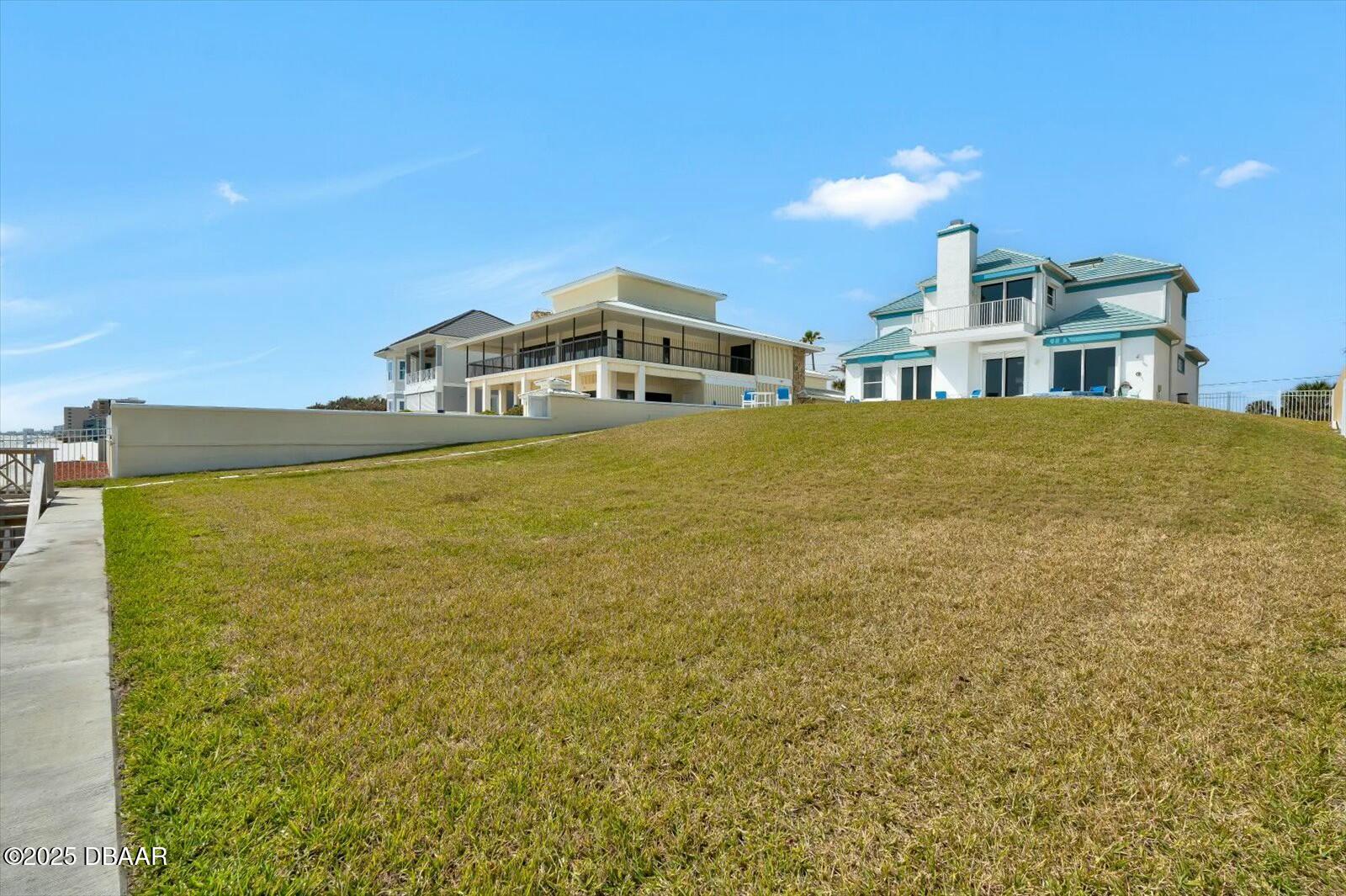 4363 South Atlantic Avenue Ponce Inlet, FL 32127 - Photo 40 of 46 a front view of a house with a yard