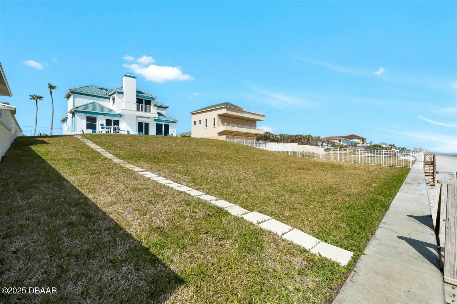 4363 South Atlantic Avenue Ponce Inlet, FL 32127 - Photo 41 of 46 a view of a lake with a building in the background